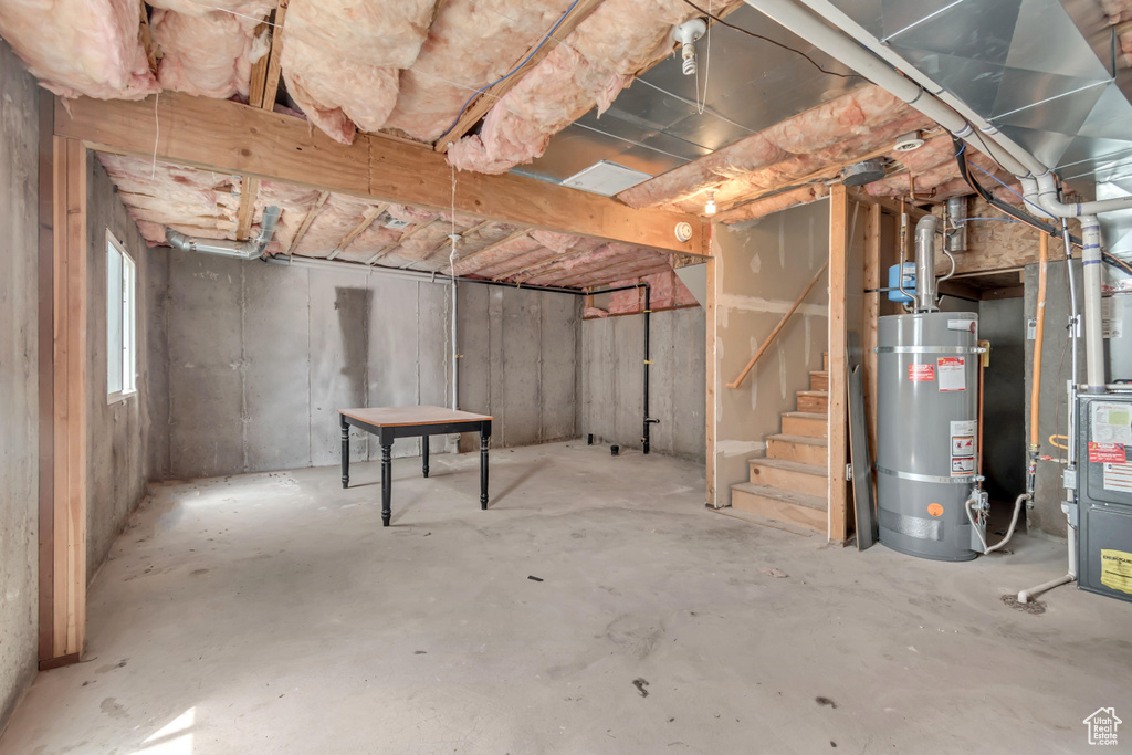 Basement with secured water heater and stairs