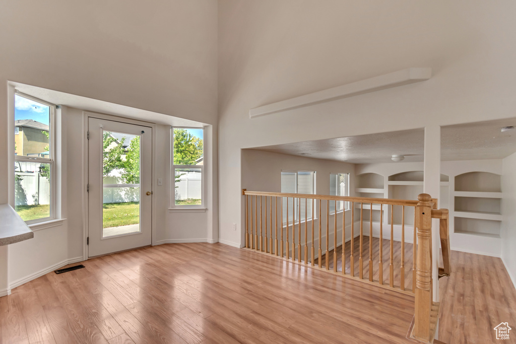 Interior space featuring baseboards, visible vents, and wood finished floors