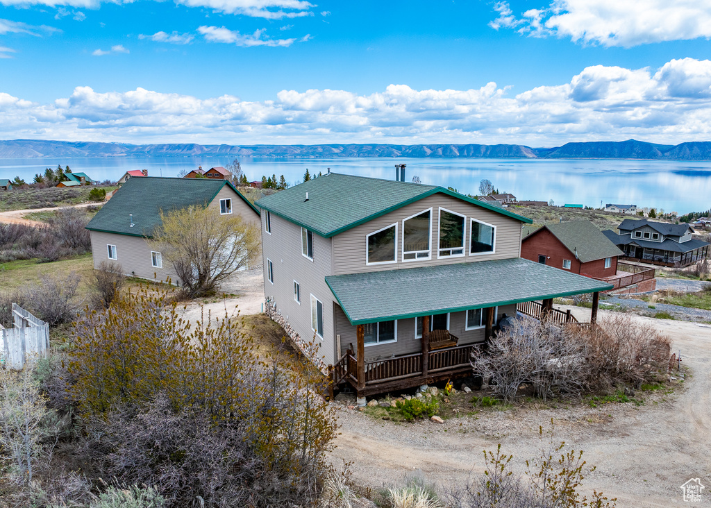 Drone / aerial view featuring a water and mountain view