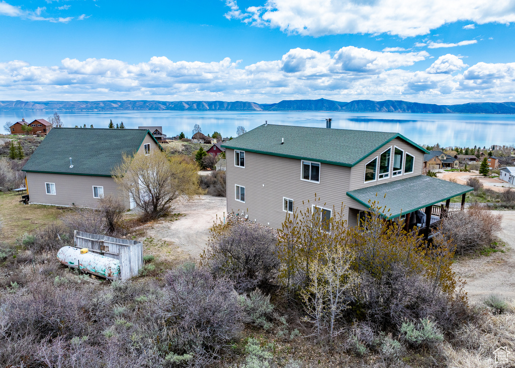 Back of property featuring a water and mountain view
