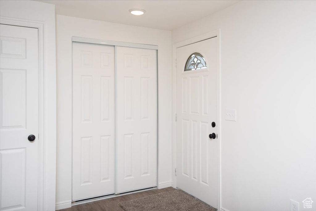 Entrance foyer with baseboards and dark wood-style floors
