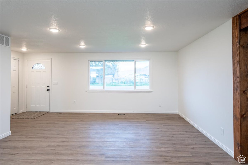 Foyer entrance with baseboards and light wood-type flooring
