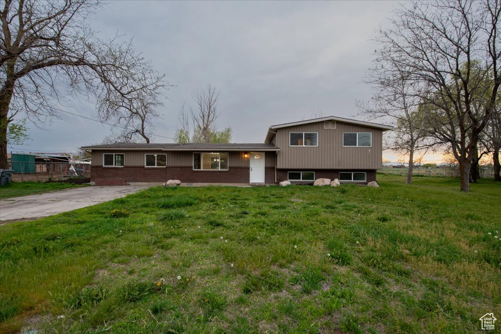 Tri-level home featuring a front lawn