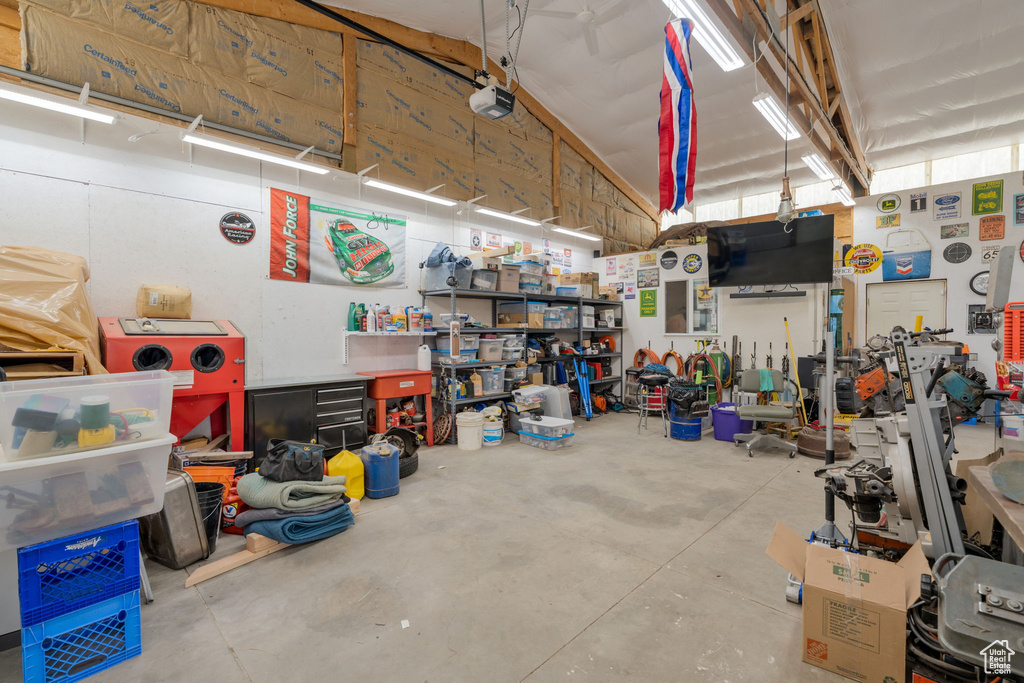 Garage featuring a workshop area and a garage door opener