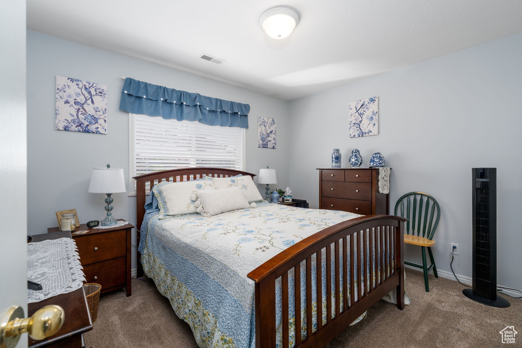 Carpeted bedroom featuring visible vents and baseboards
