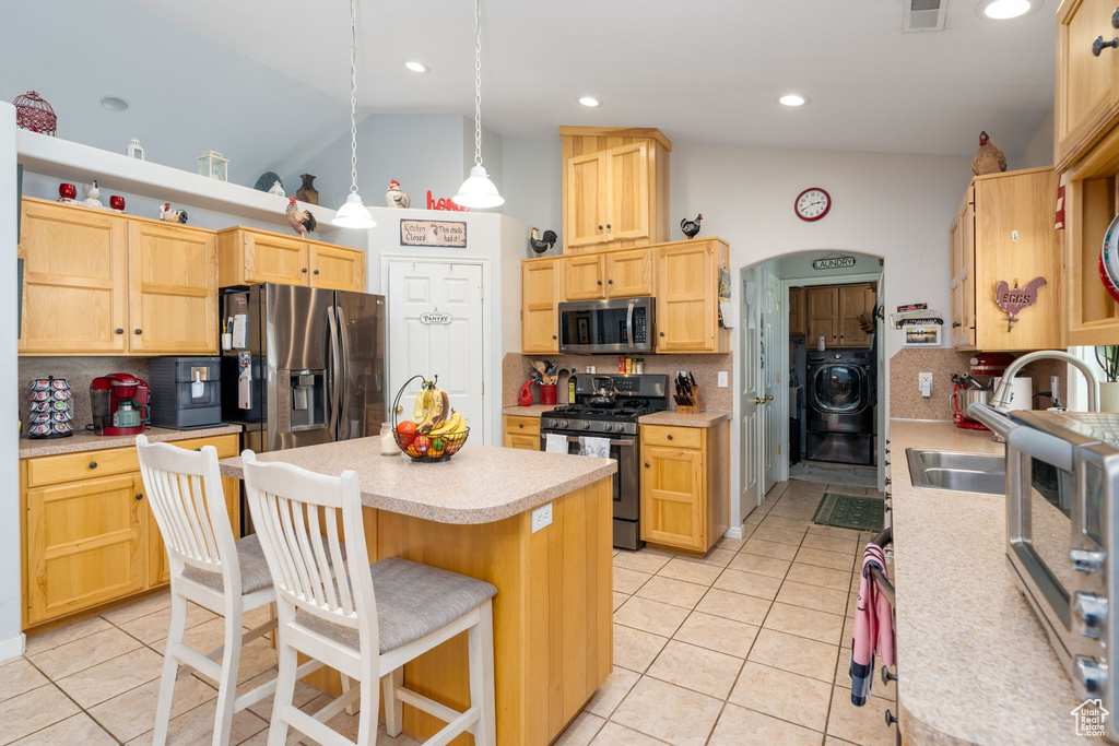 Kitchen featuring backsplash, stainless steel appliances, light countertops, and light tile patterned floors
