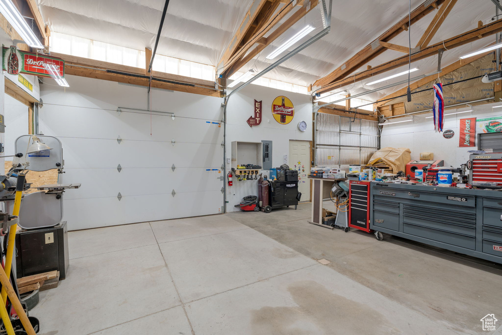 Garage with electric panel and a workshop area