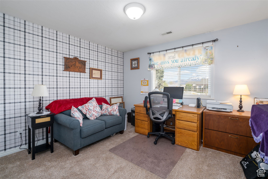 Office area featuring light carpet, an accent wall, visible vents, and wallpapered walls
