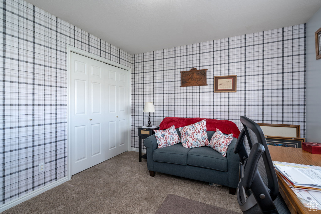 Carpeted living room with wallpapered walls