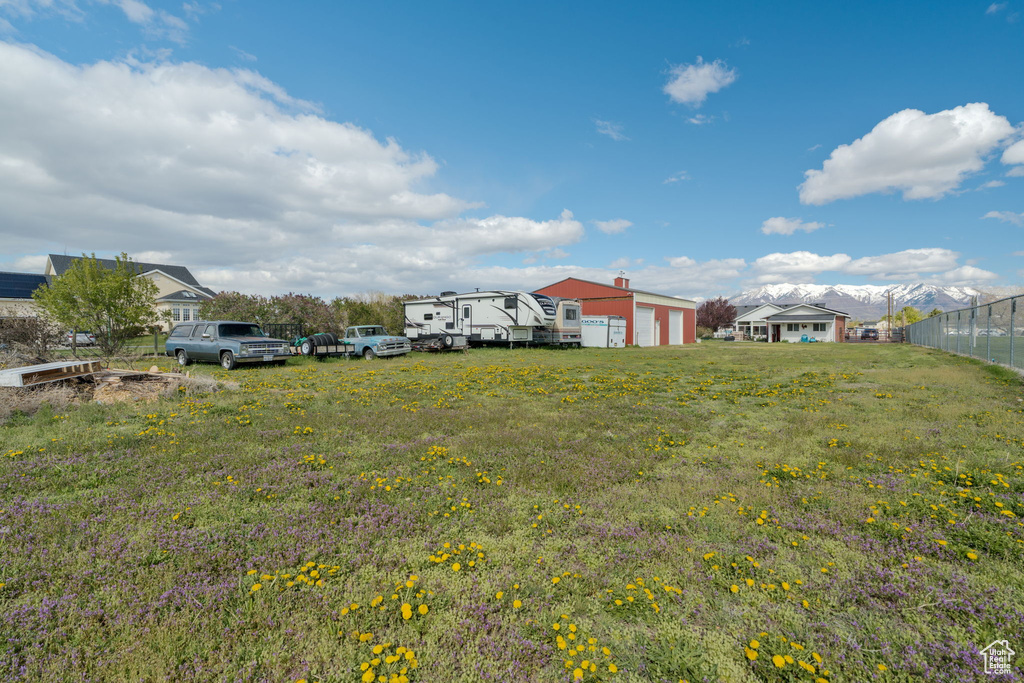 View of yard featuring a detached garage and fence