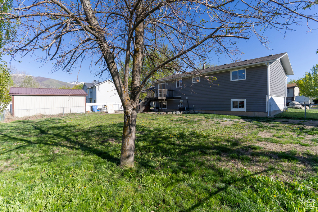 View of yard featuring stairway, fence, and a wooden deck