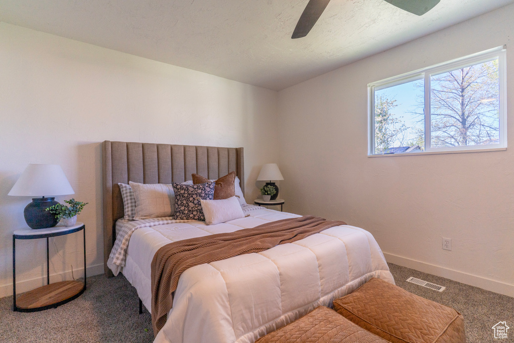 Bedroom featuring visible vents, ceiling fan, carpet, and baseboards