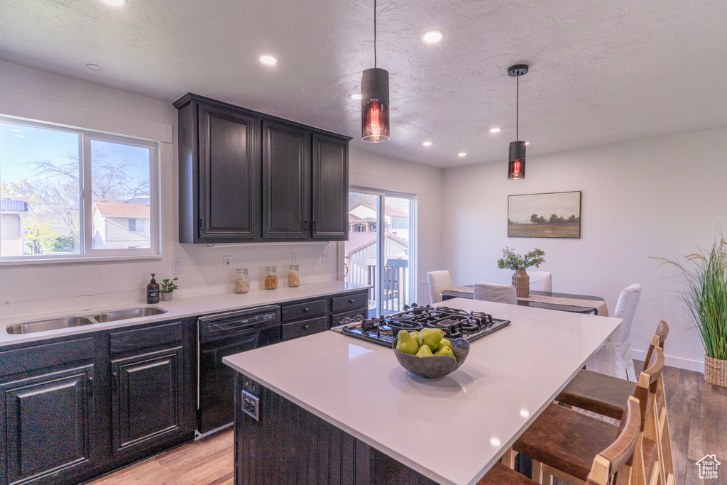 Kitchen with gas stovetop, dishwasher, light wood-style flooring, and recessed lighting