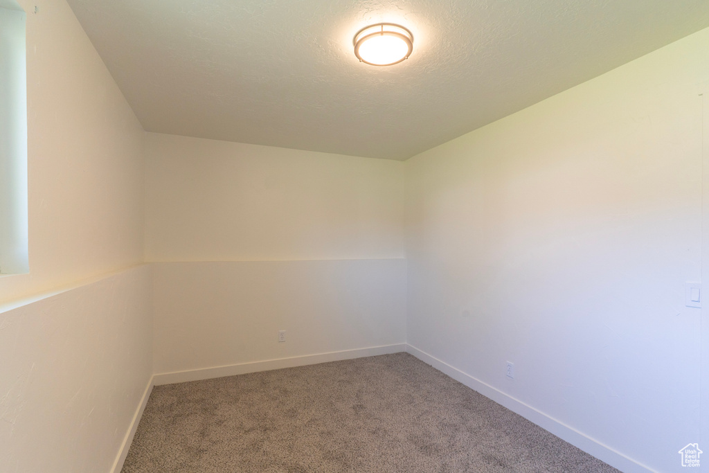 Carpeted empty room featuring baseboards