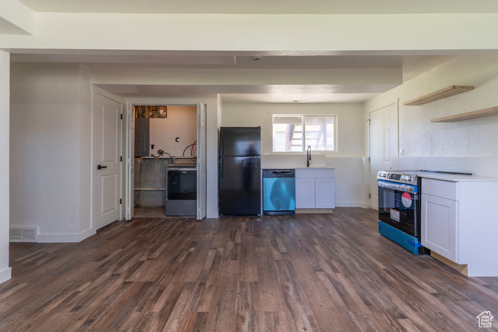 Kitchen featuring washer / dryer, electric panel, stainless steel appliances, and dark wood finished floors