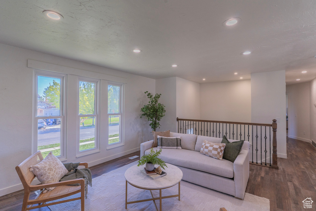 Living area featuring wood finished floors, recessed lighting, and baseboards