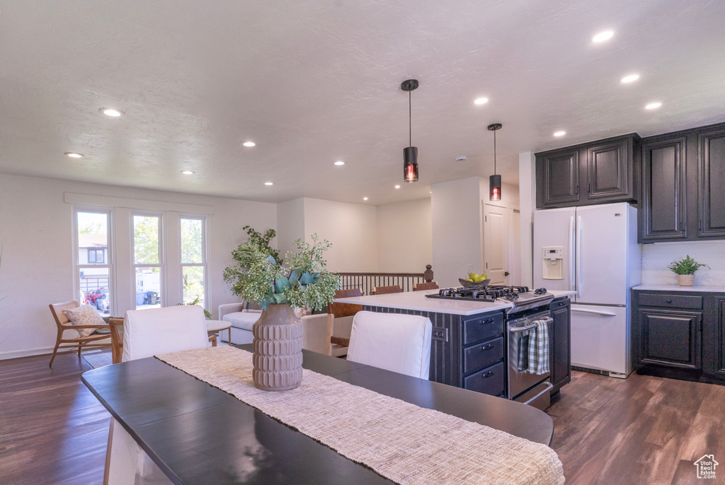 Dining space with baseboards, recessed lighting, and dark wood-type flooring