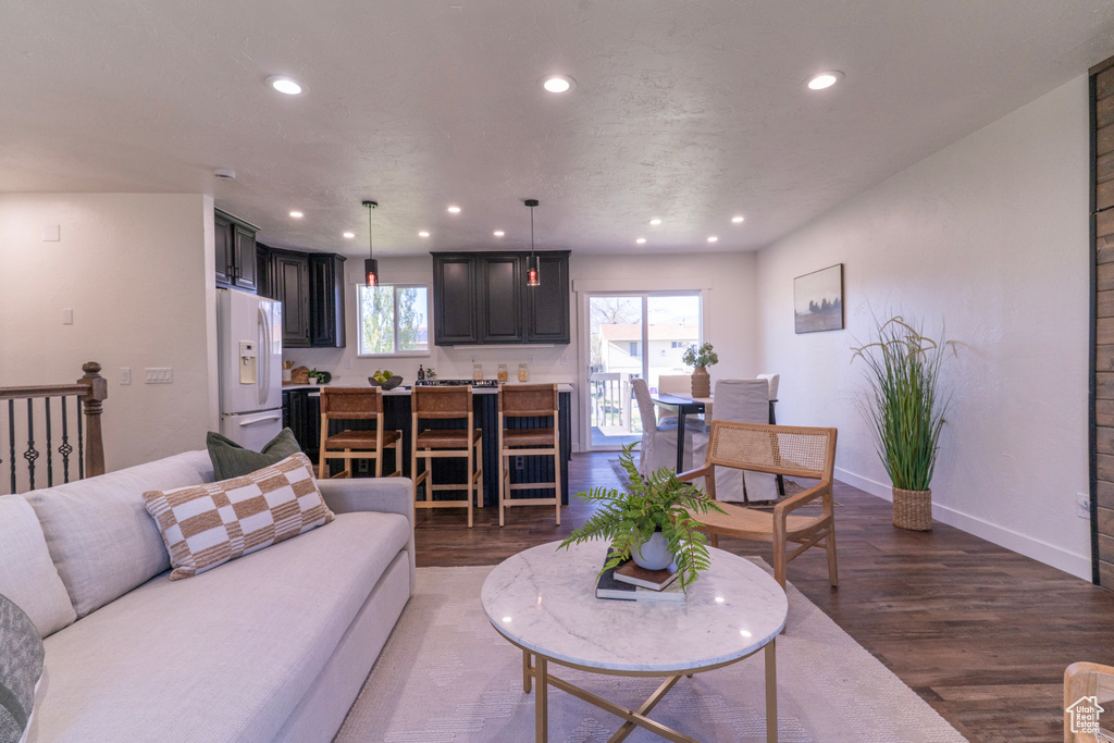 Living room featuring baseboards, recessed lighting, and wood finished floors