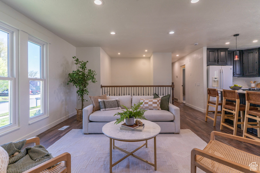 Living room featuring a healthy amount of sunlight, light wood-type flooring, and recessed lighting
