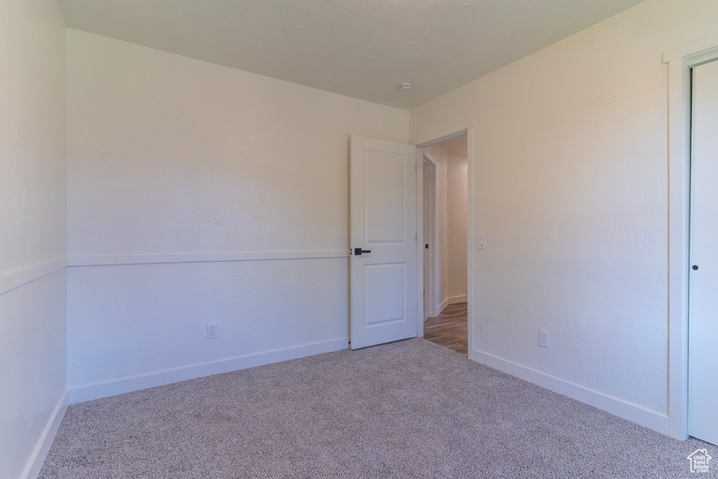 Carpeted spare room with baseboards