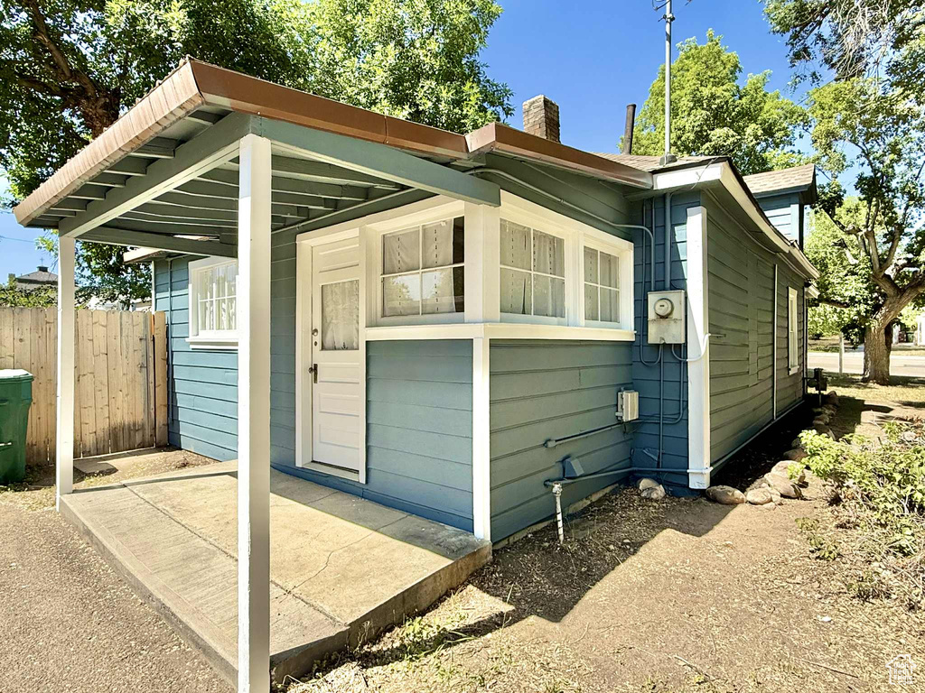 View of home\\\'s exterior featuring a chimney and a patio area