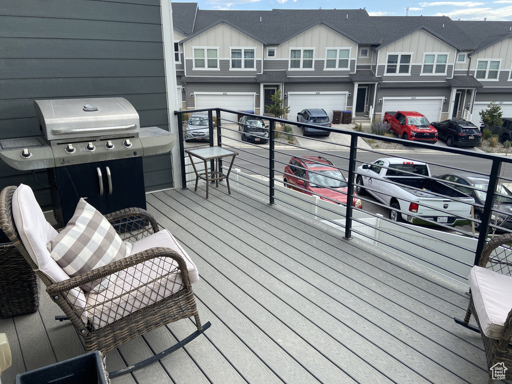 Wooden terrace with an attached garage and driveway