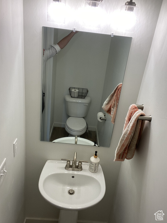 Half bathroom with toilet and a sink