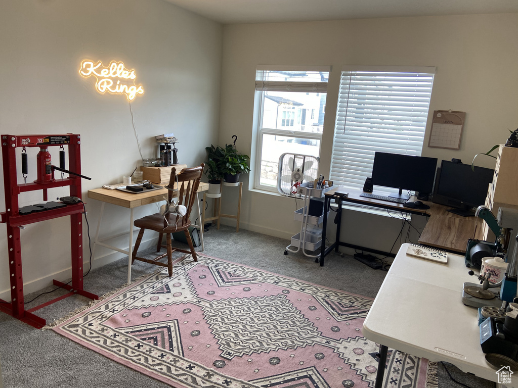 Carpeted office space featuring baseboards