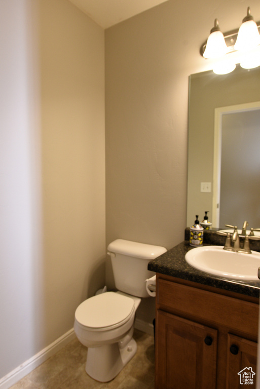 Half bath with vanity and tile patterned floors