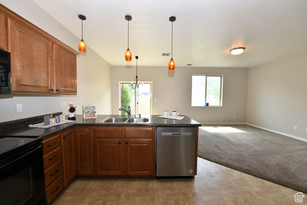 Kitchen with black appliances, a peninsula, brown cabinetry, open floor plan, and pendant lighting