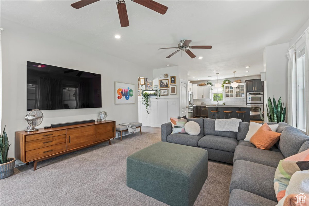 Living area with recessed lighting, carpet, and ceiling fan