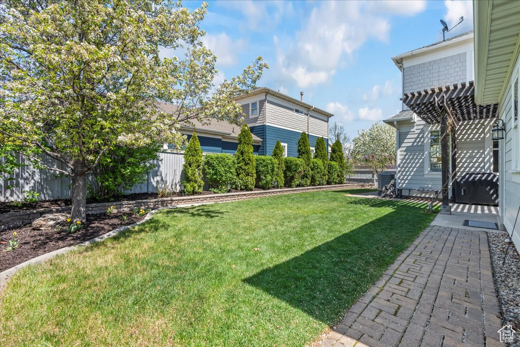 View of yard featuring a pergola and fence