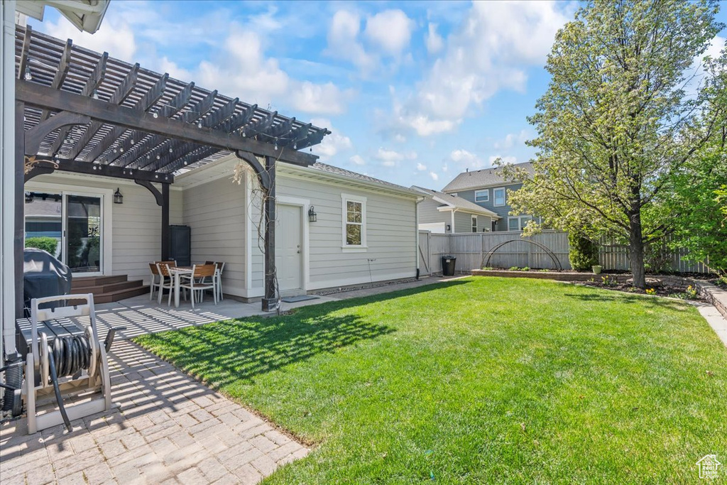 View of yard featuring a pergola, a fenced backyard, entry steps, and a patio area