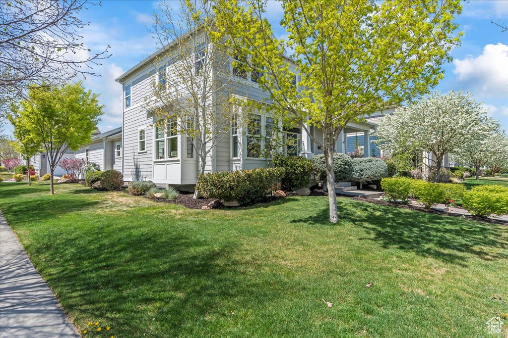 View of home's exterior with a yard