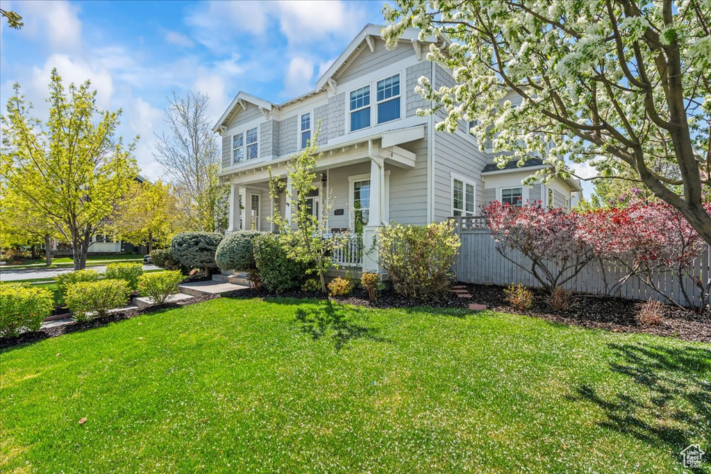 Exterior space with a porch and a front lawn