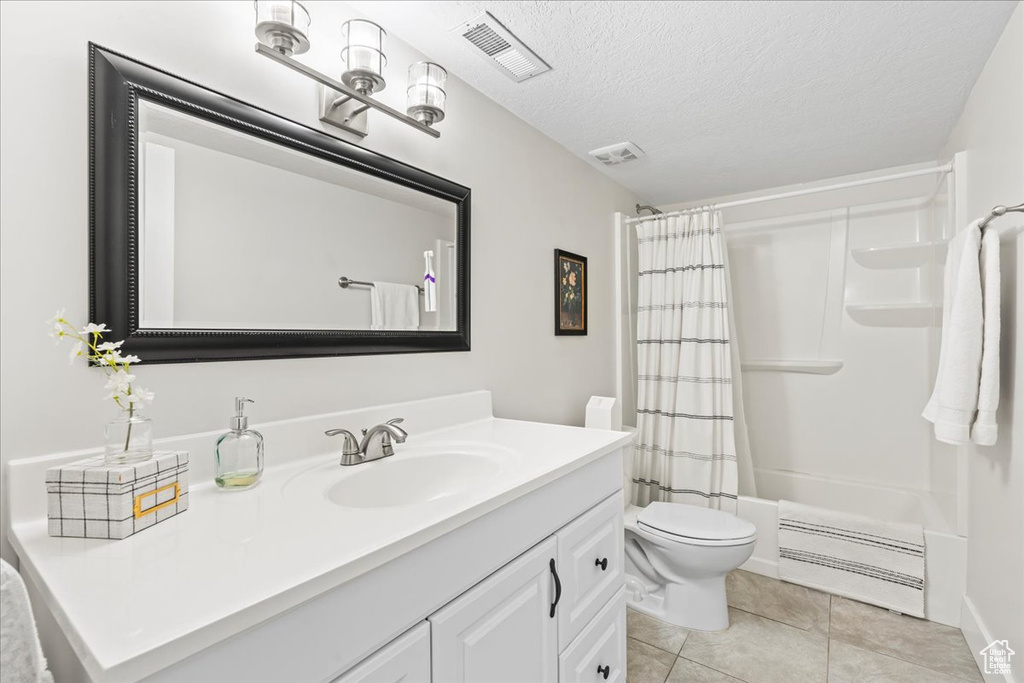 Bathroom with vanity, toilet, tile patterned flooring, and visible vents