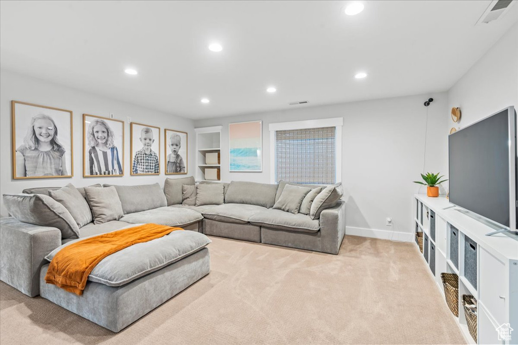 Living area with recessed lighting, carpet, visible vents, and baseboards