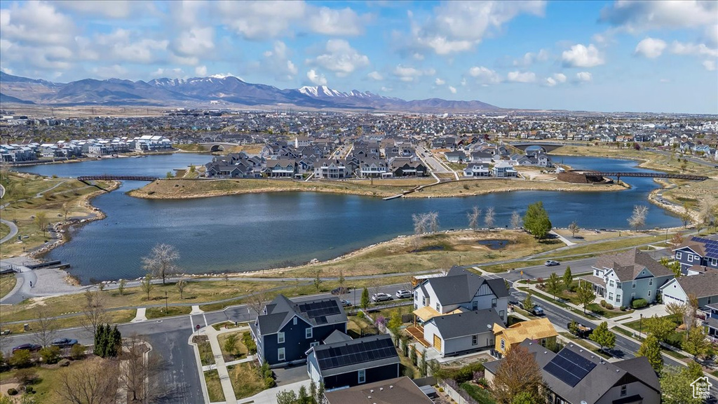 Drone / aerial view featuring a water and mountain view and a residential view