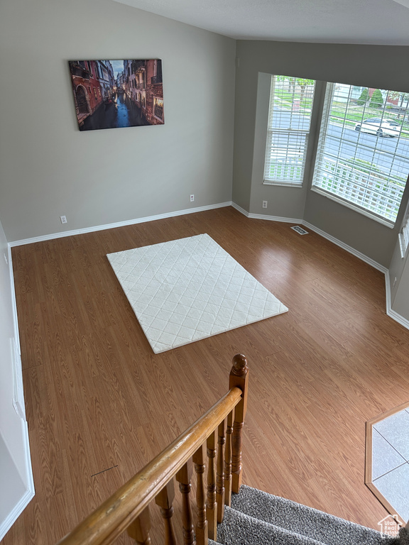 Interior space featuring baseboards, wood finished floors, and visible vents