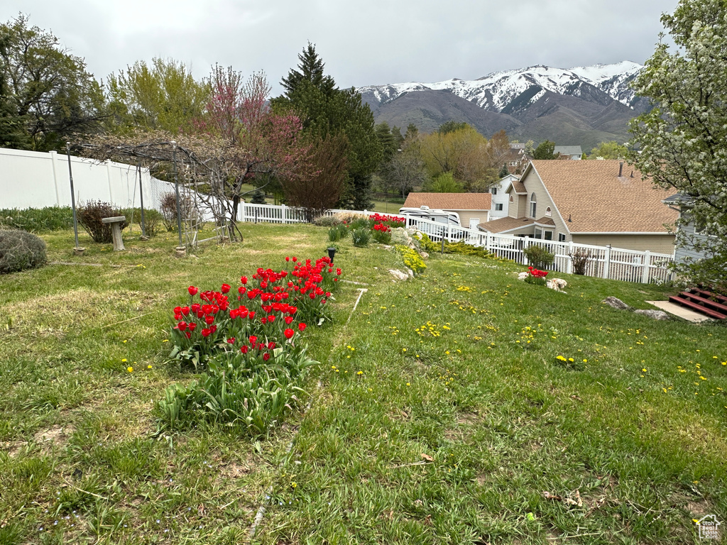 View of yard featuring a mountain view and fence