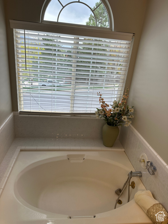 Full bathroom with plenty of natural light and a garden tub