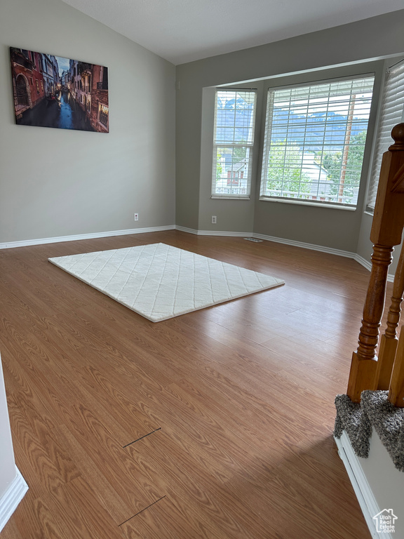 Unfurnished room featuring baseboards and wood finished floors
