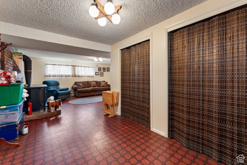 Interior space with dark floors and a textured ceiling