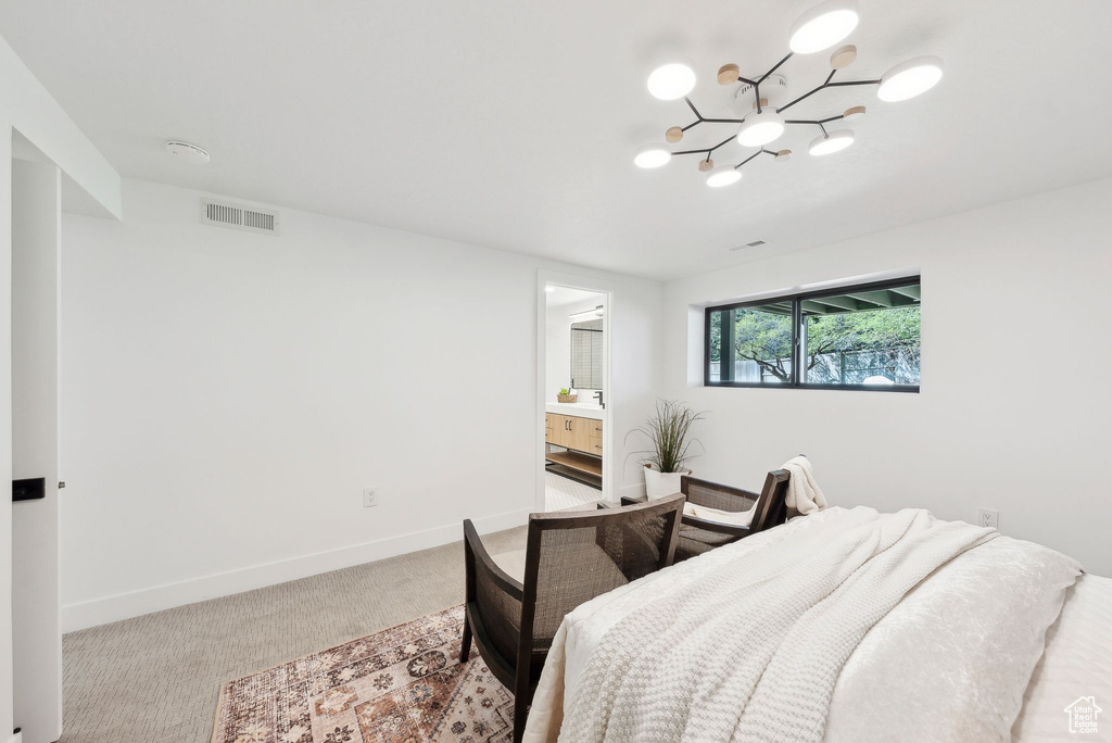 Bedroom with carpet, visible vents, baseboards, and a notable chandelier