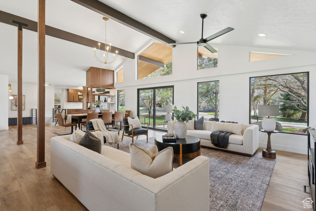 Living room featuring lofted ceiling with beams, a healthy amount of sunlight, and light wood finished floors