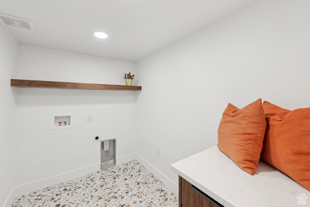 Laundry area featuring laundry area, visible vents, hookup for a washing machine, baseboards, and electric dryer hookup