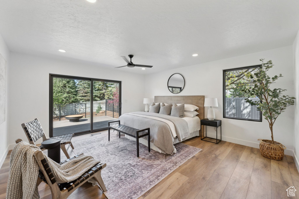 Bedroom with recessed lighting, light wood-style floors, access to exterior, and baseboards