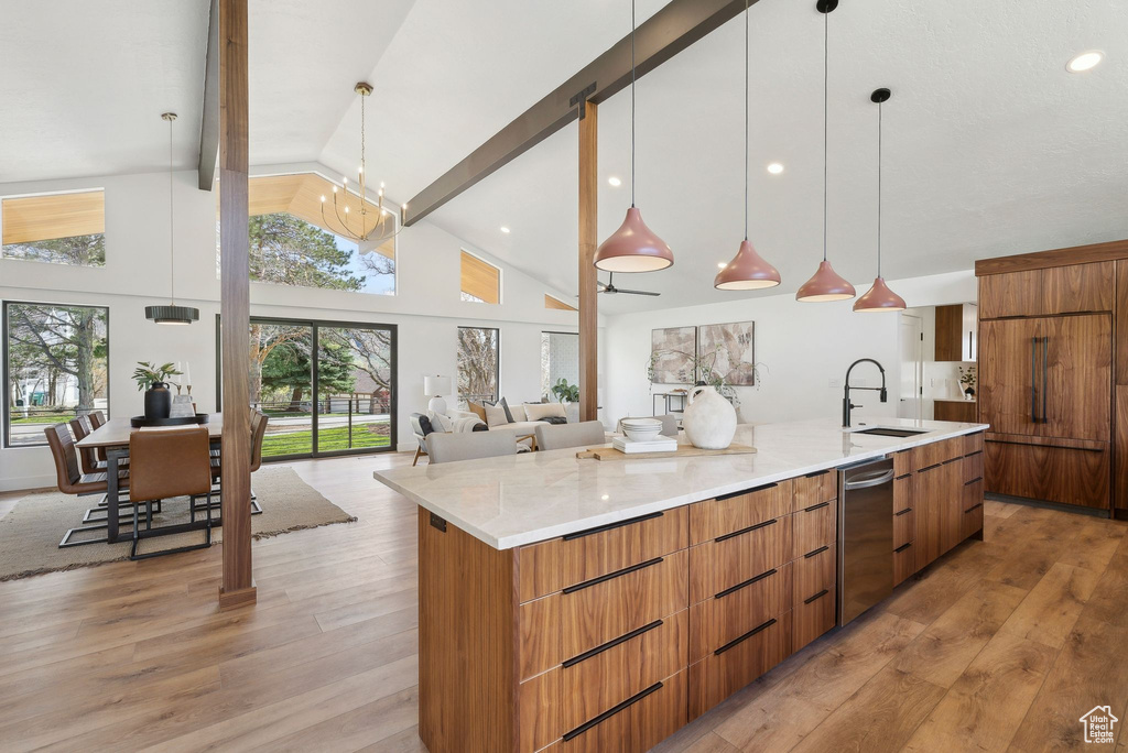 Kitchen featuring a sink, a large island, beamed ceiling, modern cabinets, and dishwasher