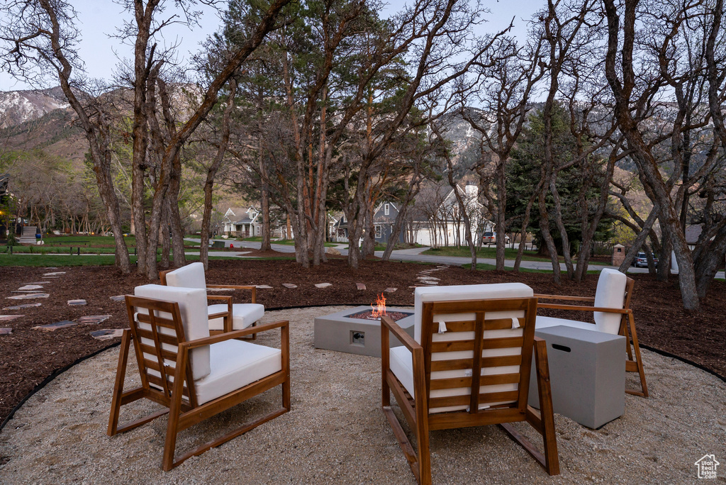 View of patio / terrace with a fire pit and a mountain view