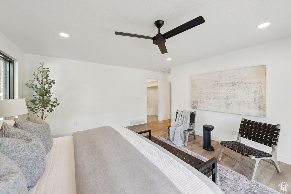 Bedroom featuring baseboards, wood finished floors, visible vents, and recessed lighting